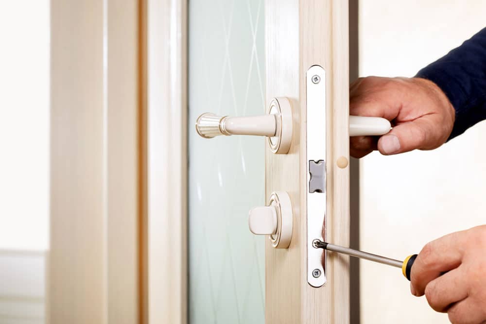 Denver’s Go-To Locksmith for Reliable Home Security A professional locksmith from Aron's Lock and Key installing a high-security deadbolt on a residential door, ensuring maximum home protection.