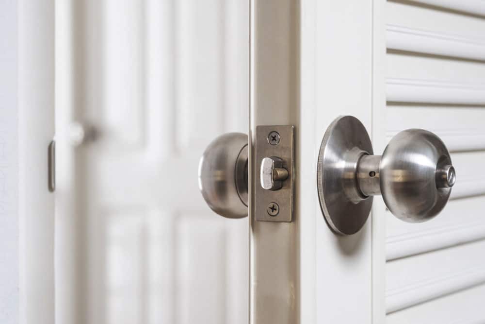 When to Rekey Your Locks | Keep Your Property Secure with Aron’s Lock and Key A locksmith rekeying a residential door lock in Denver to ensure only authorized individuals have access.
